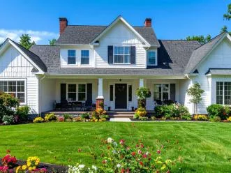 Manicured front lawn and flower beds at a two-story home