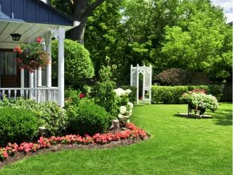 Garden beds and lawn around a front porch