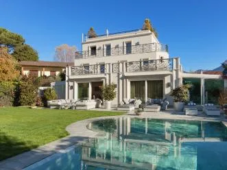 Backyard lawn maintained around a pool