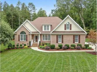 Brick home with a clean, freshly cut lawn